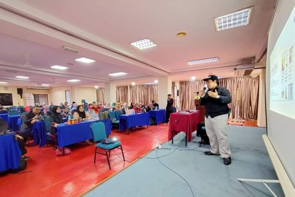 Trainer menyampaikan penerangan kepada peserta dalam sesi latihan